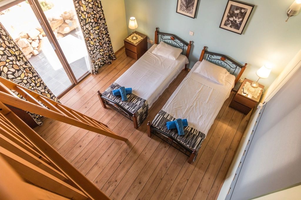 A guest room with a large bed and soft lighting