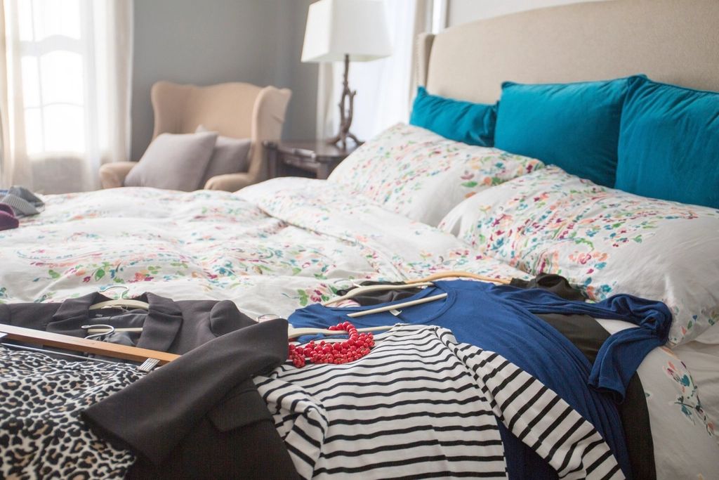 A guest room with a large bed and soft lighting